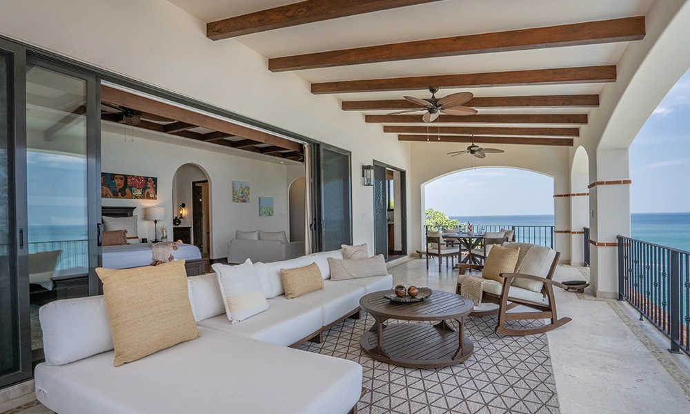 Spacious and furnished terrace with ocean view at Villa Cielo G-10 in Rancho Santana, ideal for large groups. Perfect for family gatherings and events, featuring comfortable seating areas and wooden beam ceiling.